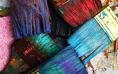 paintbrushes full of colorful paint