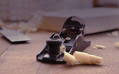 a hand plane used for woodworking and wood shavings