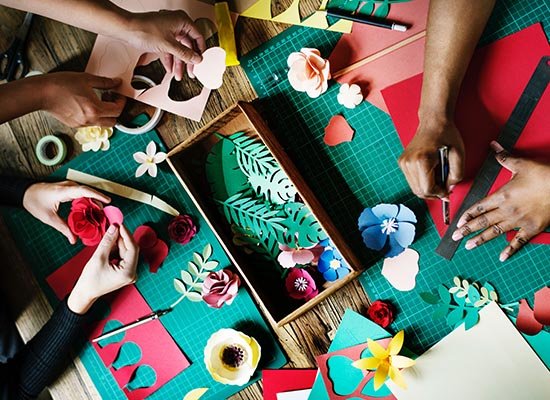 people crafting with paper