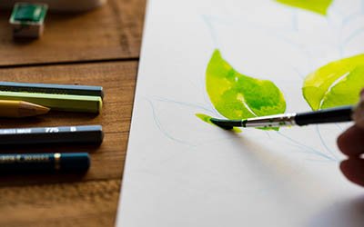 person painting with watercolors
